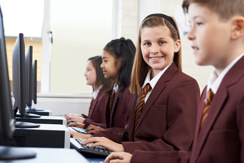 Pupils,Wearing,School,Uniform,In,Computer,Class