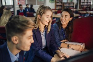 Teen,Student,Is,Working,With,Her,Teacher,On,The,Computer